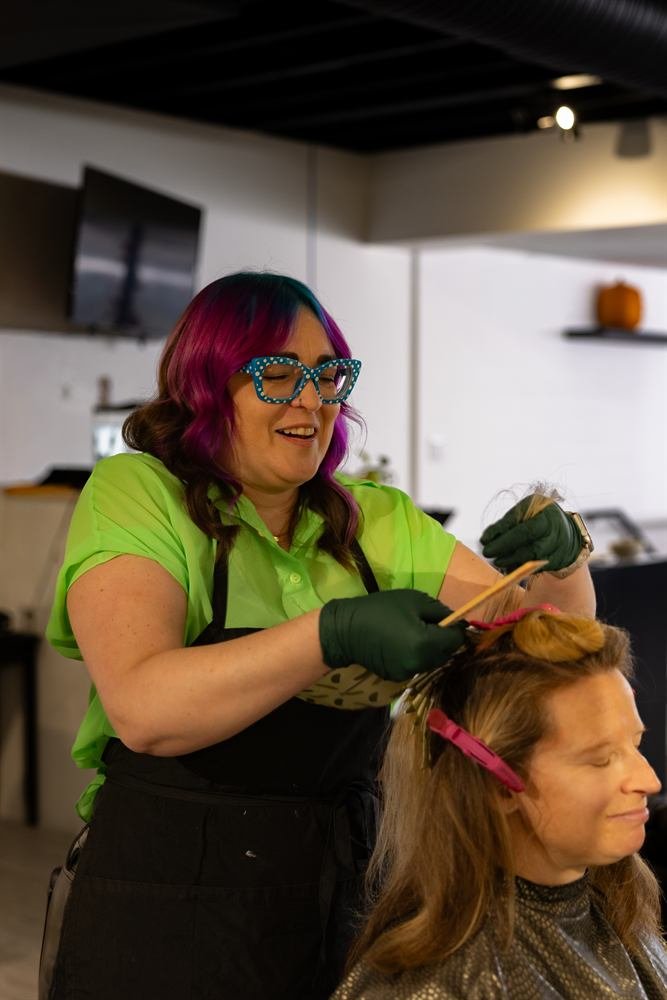 Stylist applying foils during a highlight color service