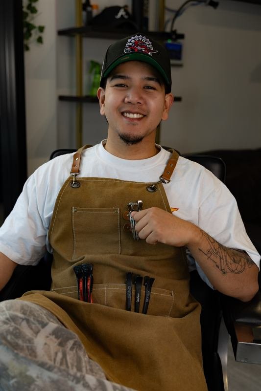 Francis, barber, wearing a leather apron and cap