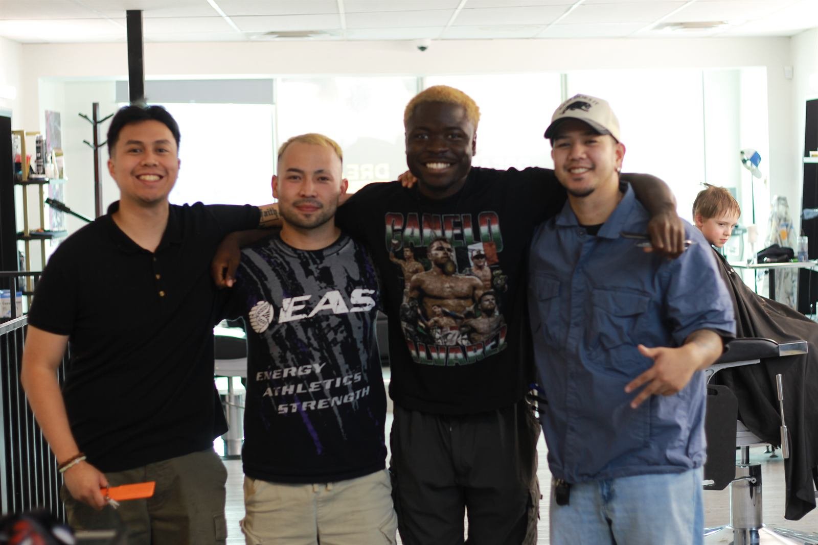 The Dream Barbers team standing together inside the shop